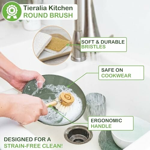 Person using a round brush to clean a dish in the sink.