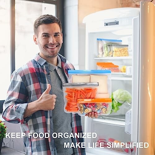 Man organizing fridge with reusable bags, giving thumbs up.