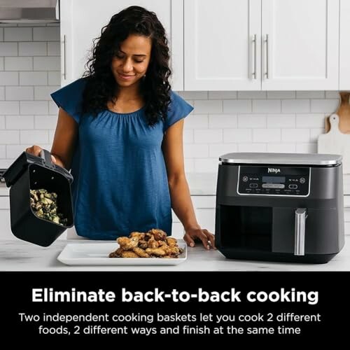 Woman using Ninja dual basket air fryer in kitchen.