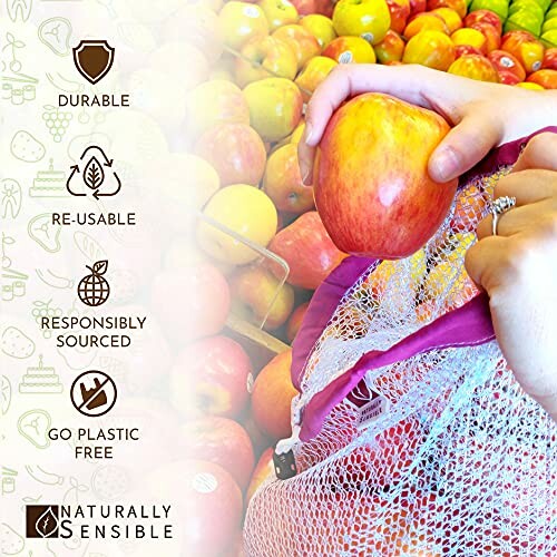 Hand placing apple in reusable produce bag with fruits in background.