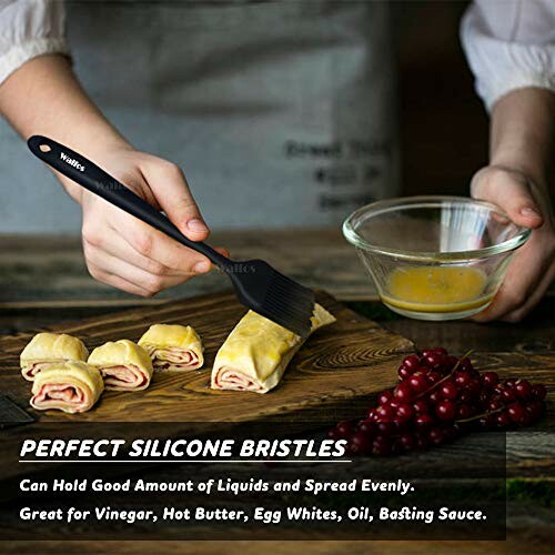 Person using a silicone basting brush on pastries with a bowl of liquid.