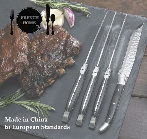 Set of steak knives with ribs on slate board.