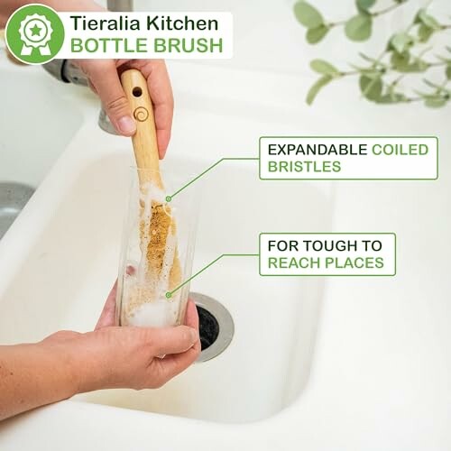 Person using Tieralia kitchen bottle brush with expandable coiled bristles in a sink.